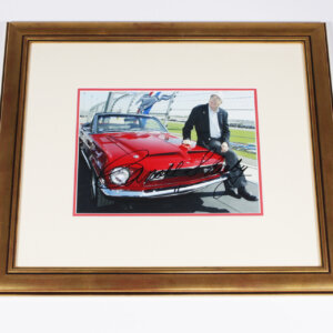 Framed photograph of Shelby in front of a 68 Shelby Mustang